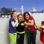 kids in front of south pole backdrop